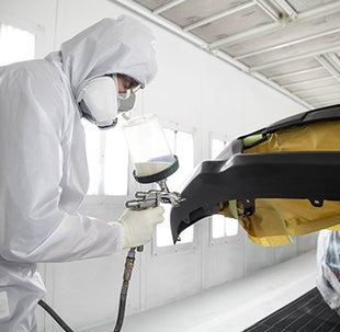 Collision Center Technician Painting a Vehicle | Bob Rohrman Toyota in Lafayette IN