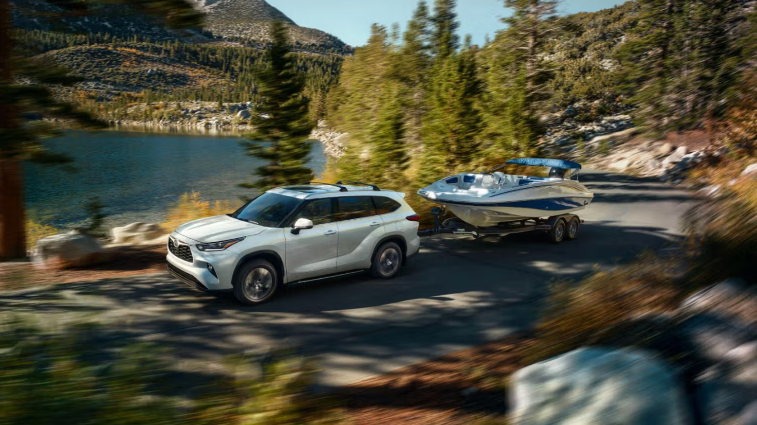 Toyota Highlander hauling a boat at a lake near Indianapolis