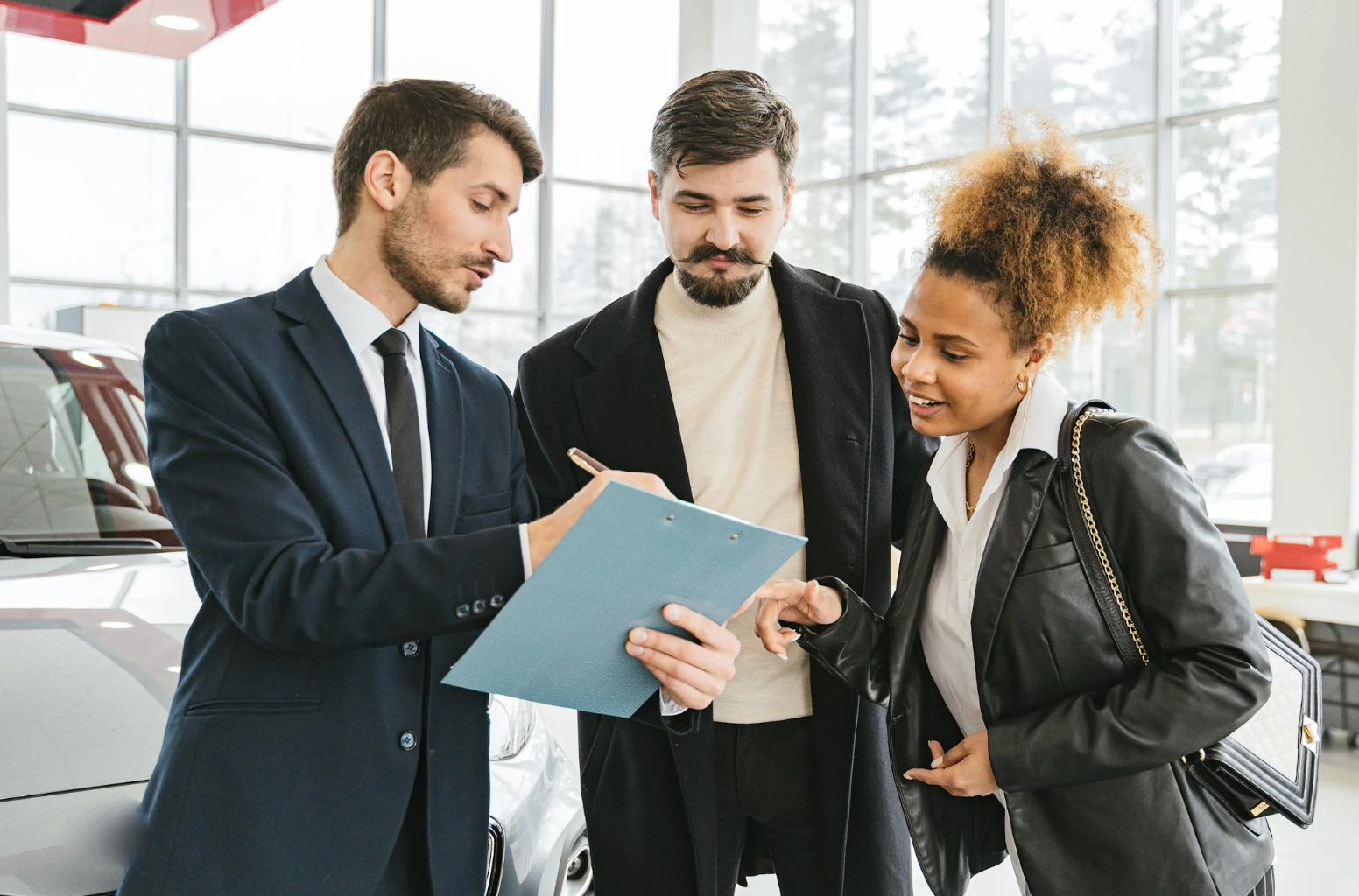 People leasing a vehicle from a dealership