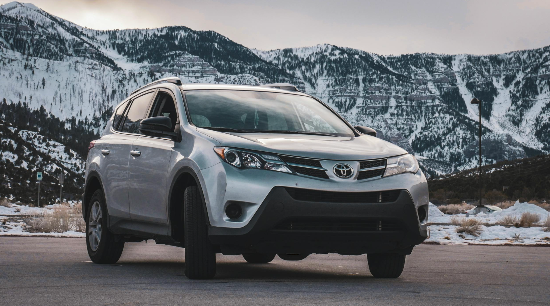Toyota RAV4 in front of snowy mountains